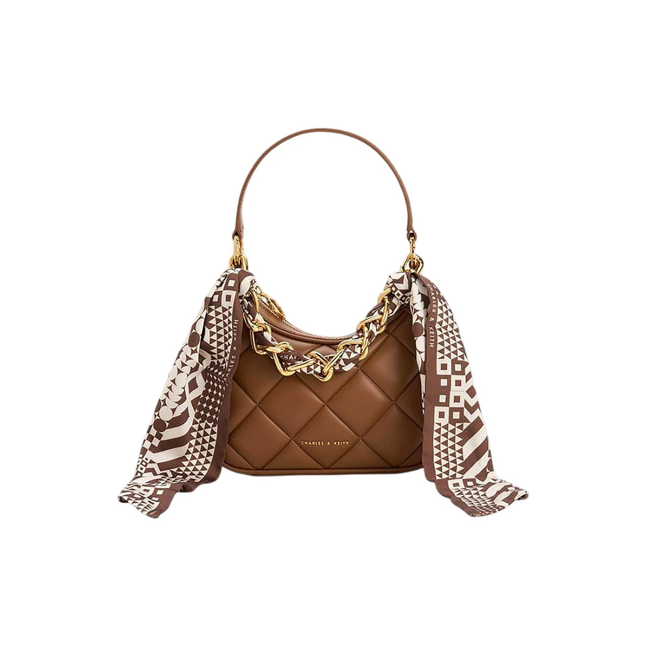 Brown quilted handbag with a patterned scarf draped over it on a white background