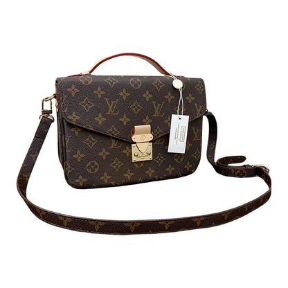 Designer handbag with monogram pattern and gold lock on a white background