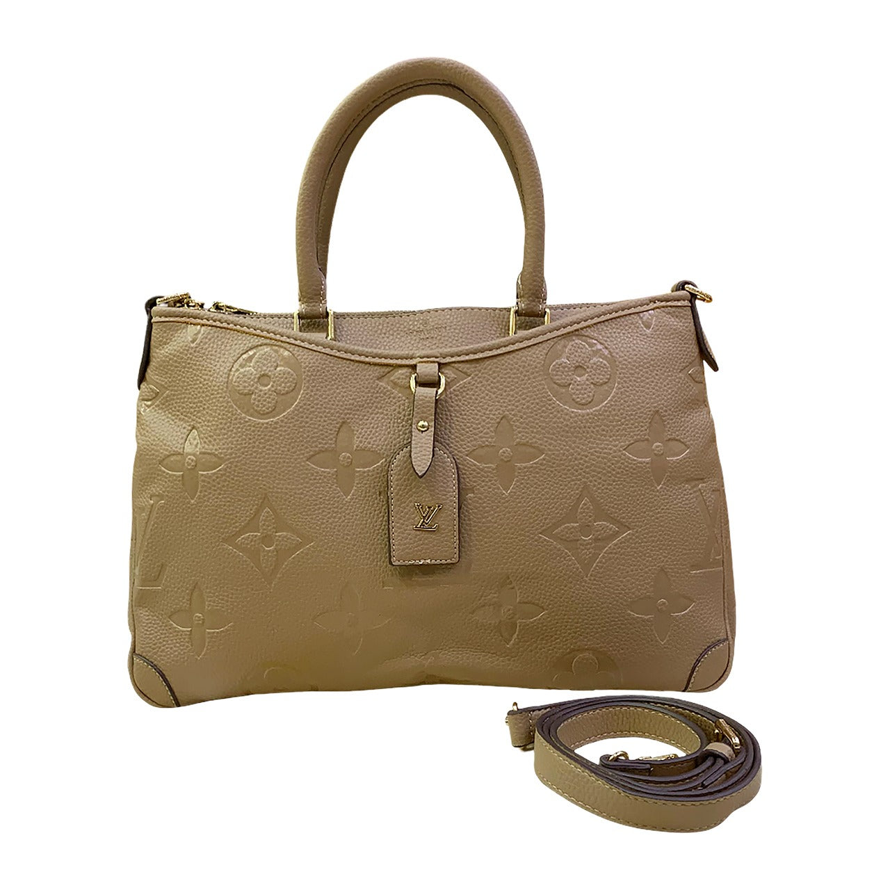 Beige handbag with monogram pattern and matching strap on a white background