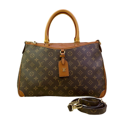 Designer handbag with monogram pattern and detachable strap on a white background