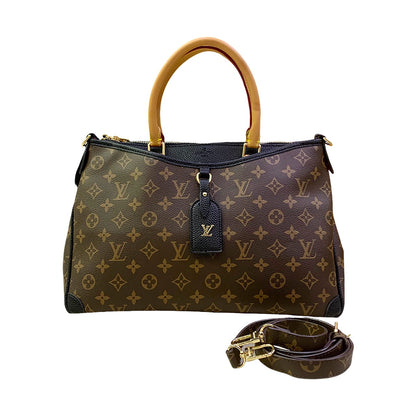 Designer handbag with monogram pattern and detachable strap on a white background